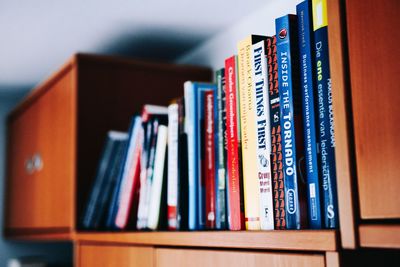 Close-up of books in shelf at home