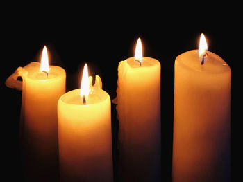 Close-up of lit candles in the dark