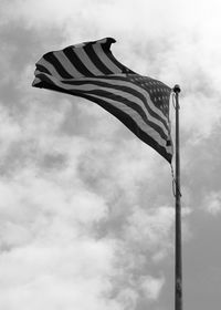 Low angle view of flags against sky