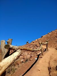 Low angle view of land against clear blue sky