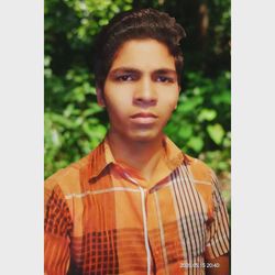 Portrait of teenage boy standing outdoors