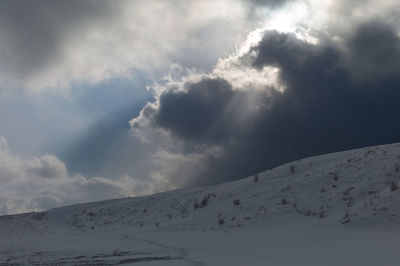 Low angle view of snowcapped mountain against sky