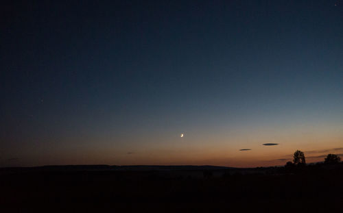 Scenic view of silhouette landscape against sky at night