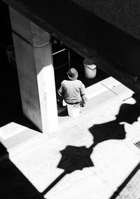 High angle view of man shadow on tiled floor