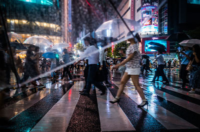 People walking on street in city at night