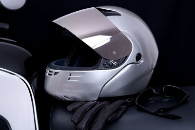 Close-up of crash helmets and gloves on seat