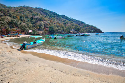 People on beach against sky