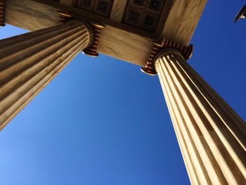 Academy of athens columns against clear blue sky
