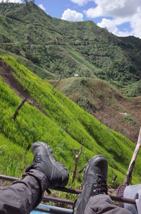 Low section of man standing on mountain