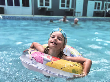 Portrait of smiling young woman in swimming pool