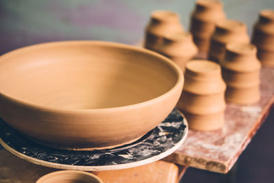 Ceramic clay products stand on the shelf close-up. sculptor sculpts pots products from white clay
