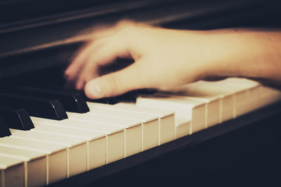 Close-up of hands playing piano