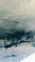 Scenic view of snow covered landscape against cloudy sky