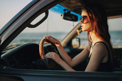 Young woman sitting in car