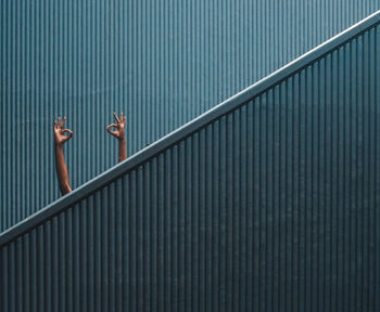 Hand sign on minimal staircase