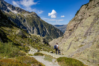 People on mountain against sky