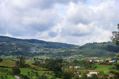 Scenic view of mountains against cloudy sky