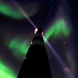 Low angle view of illuminated lights against sky at night