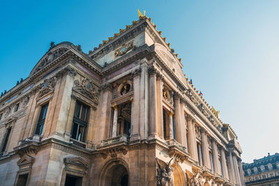 Low angle view of historical building against clear blue sky