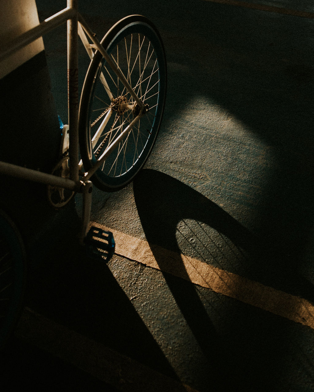 HIGH ANGLE VIEW OF SHADOW ON WOODEN FLOOR