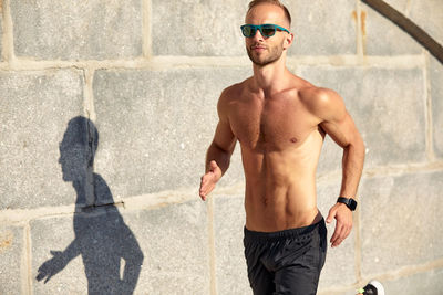 Low section of man standing on road