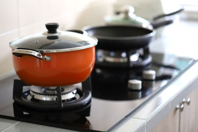 Stew pot and cooking pan on stove at home