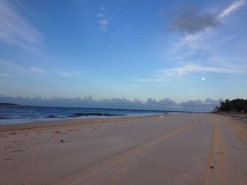 Scenic view of beach against blue sky