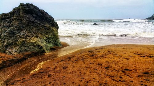 Scenic view of golden beach against sky