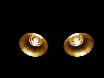 Close-up of illuminated lamp against black background