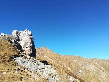 Scenic view of rocky mountains against clear blue sky