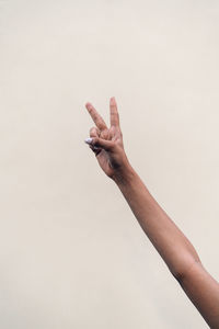 Close-up of hand gesturing against white background