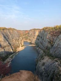 High angle view of river amidst rocks against sky