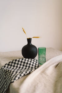 Modern dining table setting. a beautiful black vase with a linen napkin on the table.