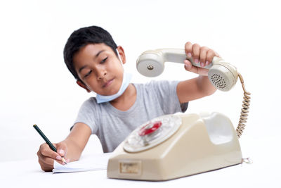 Full length of boy holding mobile phone