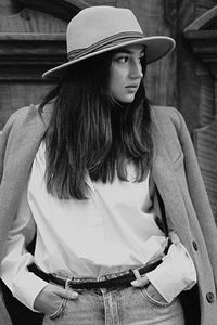 Young woman wearing hat looking away outdoors