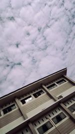 Low angle view of building against cloudy sky