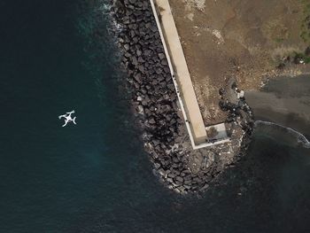 Aerial view of mountain by sea