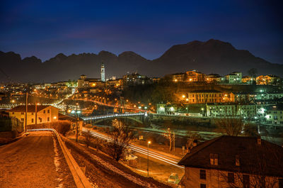 High angle view of illuminated buildings against sky at night