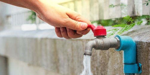 Close-up of hand holding red water