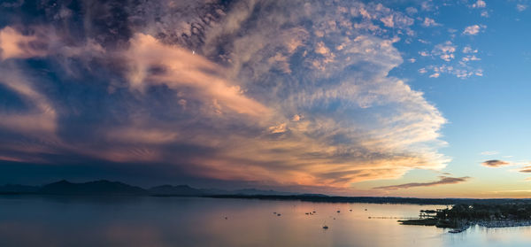 Scenic view of lake against sky at sunset