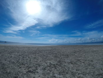 Scenic view of beach against blue sky