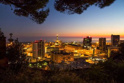 High angle view of illuminated buildings against sky at sunset