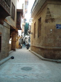 Narrow street amidst buildings in city