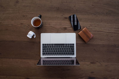 High angle view of laptop and book on table