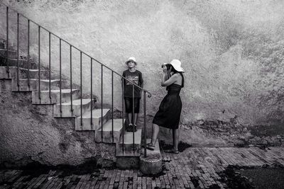 Full length of woman standing by railing