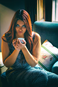 Portrait of a young woman sitting outdoors