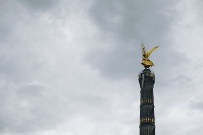 Low angle view of statue against cloudy sky