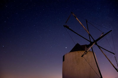 Low angle view of wind turbine against sky at night