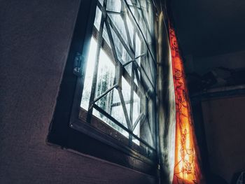 Low angle view of illuminated glass window in building