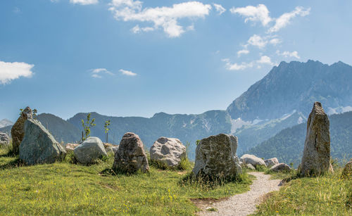 Panoramic shot of rocks on field against sky